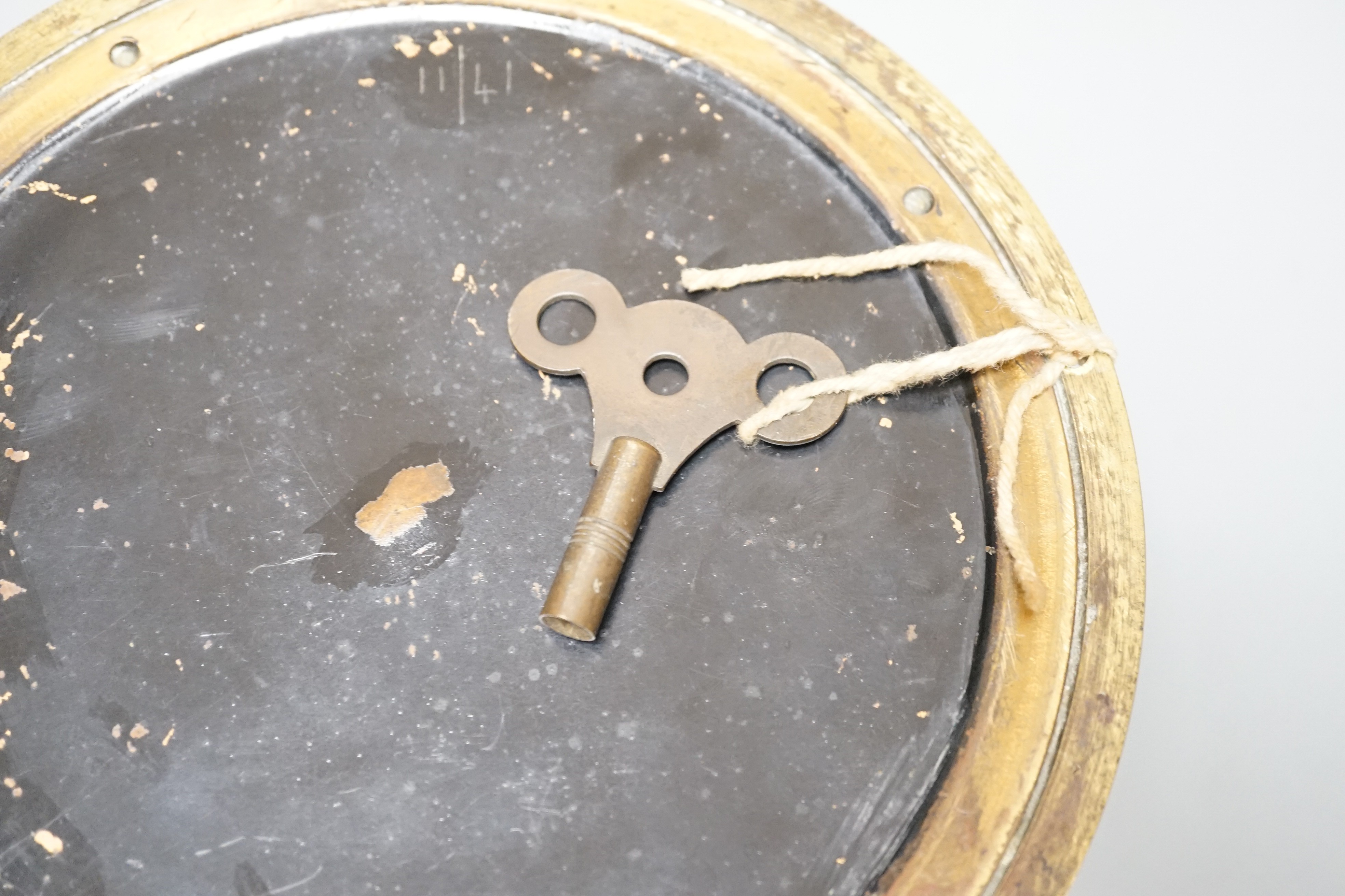 An early 20th century brass ships bulkhead timepiece with key